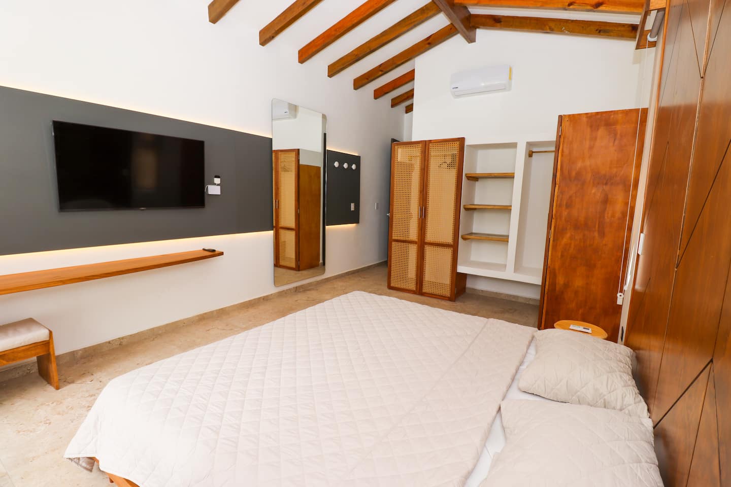 Master bedroom with Smart TV and custom woodwork