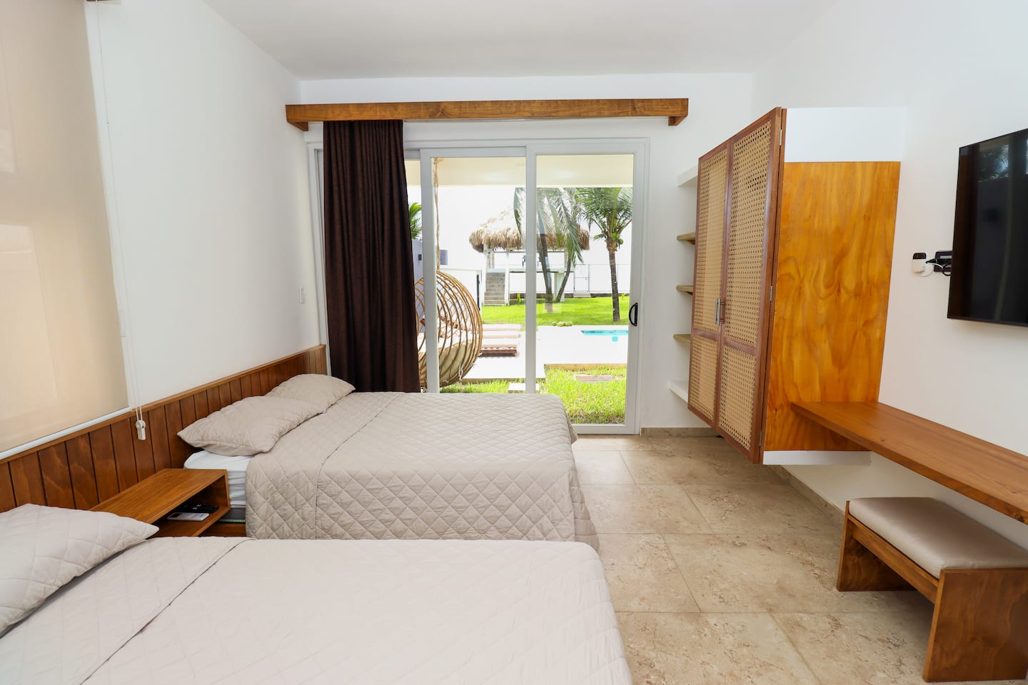 Bedroom 2 with two double beds and garden view
